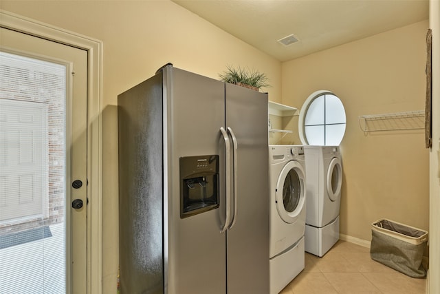 laundry room featuring light tile patterned floors and washer and clothes dryer