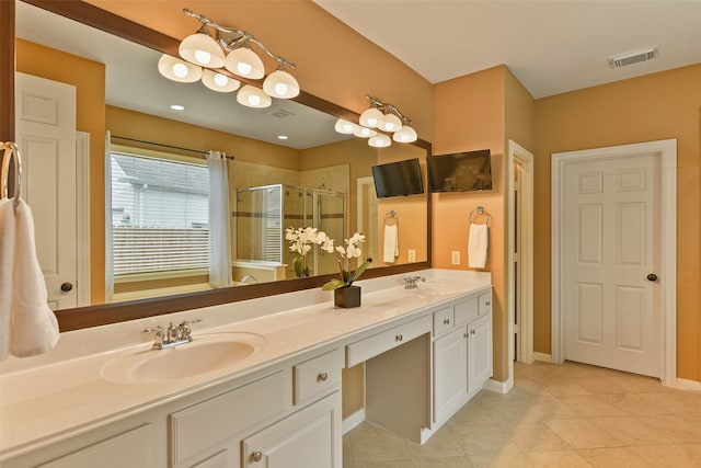 bathroom with tile patterned floors, vanity, and a shower with shower door