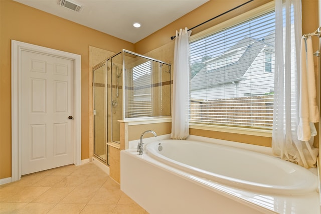 bathroom featuring tile patterned floors and independent shower and bath