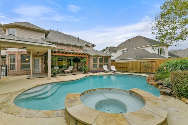 view of pool featuring a patio area and an in ground hot tub