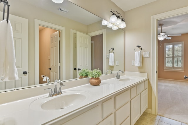 bathroom with tile patterned flooring, vanity, and ceiling fan