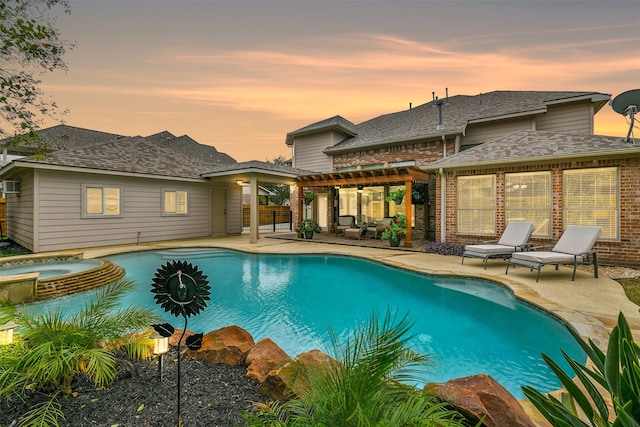 pool at dusk featuring an in ground hot tub, a pergola, and a patio