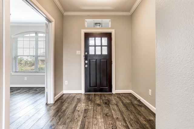 foyer with ornamental molding and dark hardwood / wood-style floors