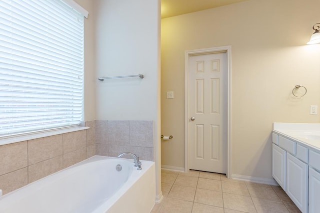 bathroom with vanity, tile patterned floors, and a washtub