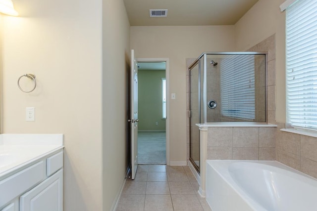 bathroom featuring vanity, tile patterned floors, and separate shower and tub