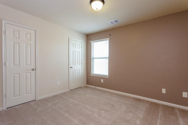 unfurnished bedroom with light colored carpet