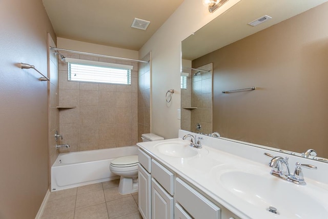 full bathroom featuring tiled shower / bath, vanity, toilet, and tile patterned flooring