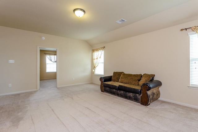 carpeted living room featuring lofted ceiling