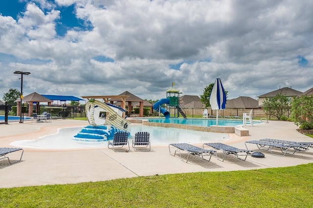 view of pool with a patio and a water slide