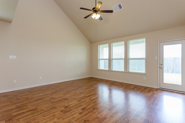 spare room with high vaulted ceiling, a wealth of natural light, and dark hardwood / wood-style floors