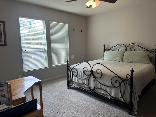 carpeted bedroom with a textured ceiling and ceiling fan