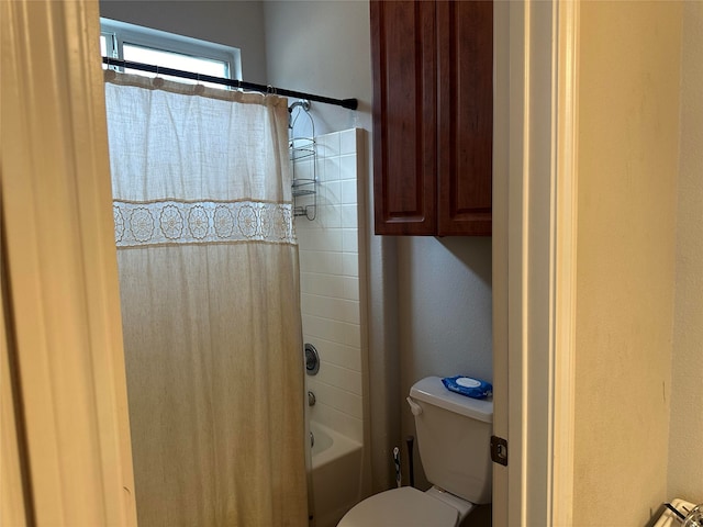 bathroom with toilet and shower / bath combo with shower curtain