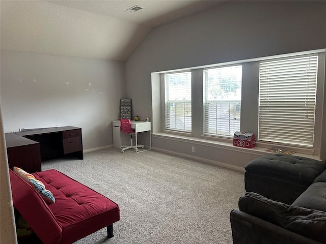 sitting room with carpet flooring and vaulted ceiling