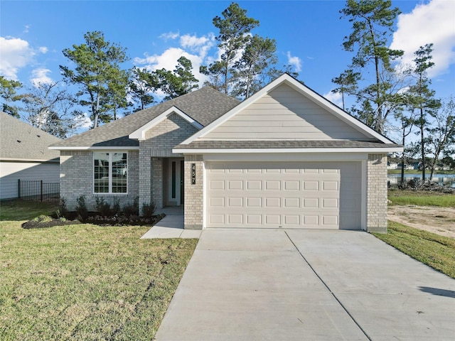 view of front of property with a garage and a front yard