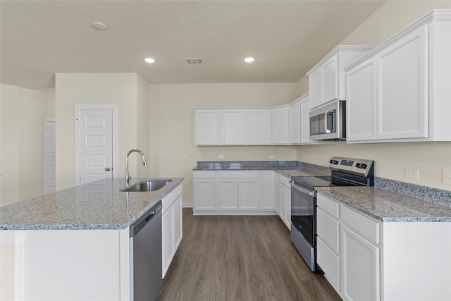 kitchen featuring a kitchen island with sink, white cabinetry, sink, and stainless steel appliances