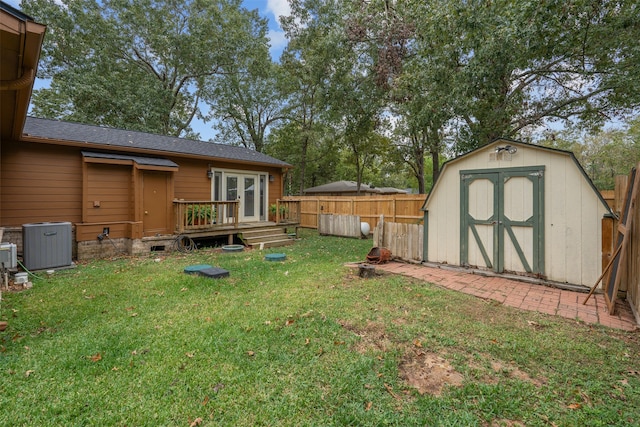 view of yard with a deck and a storage shed