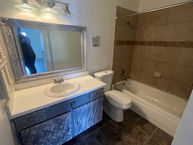 full bathroom featuring vanity, toilet, tiled shower / bath combo, and tile patterned floors