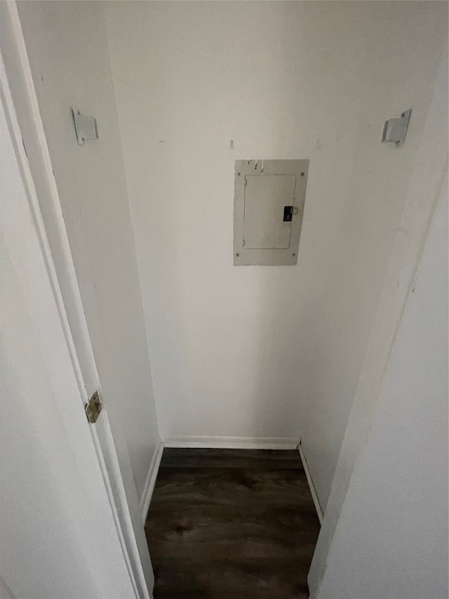 washroom with electric panel and dark hardwood / wood-style flooring