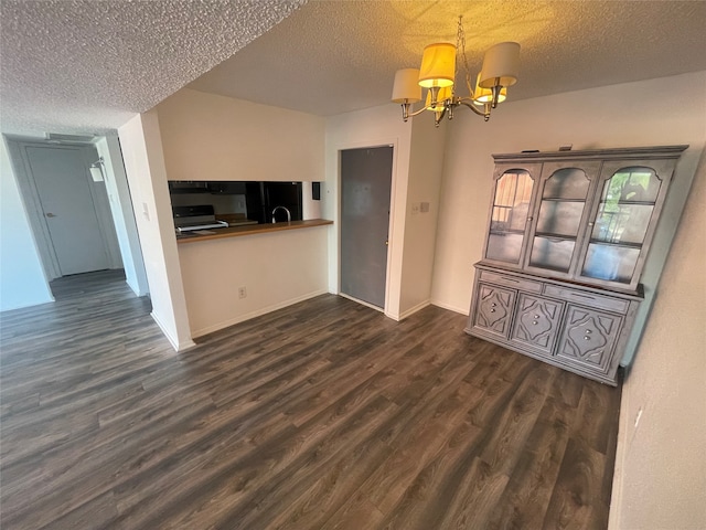 unfurnished living room featuring a textured ceiling, a chandelier, and dark hardwood / wood-style flooring