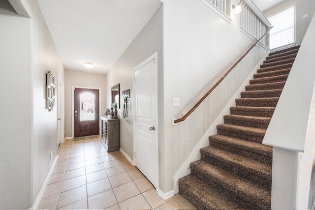 foyer entrance featuring light tile patterned floors and plenty of natural light