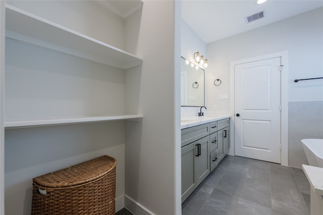 bathroom with a tub and vanity