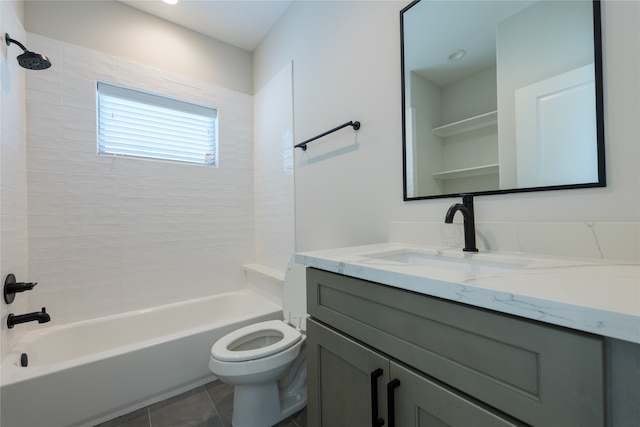 full bathroom featuring vanity, tile patterned flooring, tiled shower / bath, and toilet