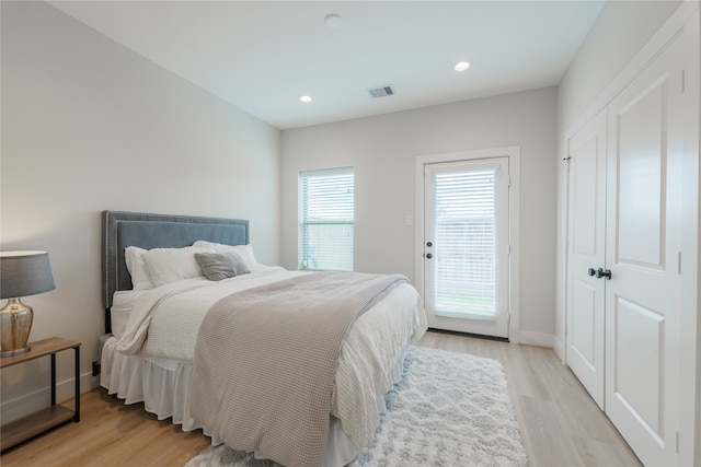 bedroom with access to outside and light wood-type flooring