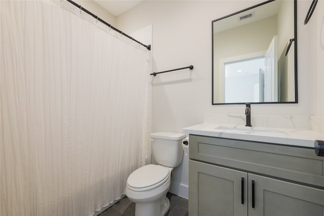 bathroom featuring vanity, tile patterned flooring, and toilet