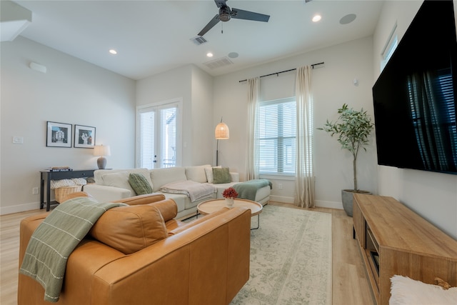 living room with light wood-type flooring and ceiling fan