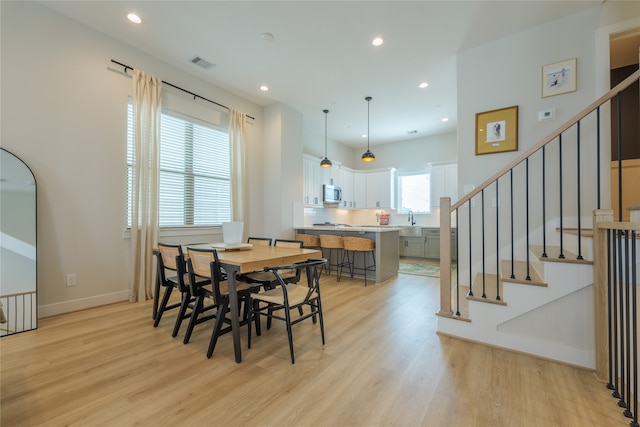 dining space featuring light hardwood / wood-style floors and sink