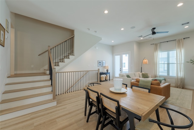 dining area with light hardwood / wood-style floors and ceiling fan