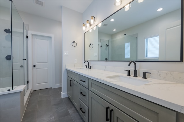 bathroom with vanity and a shower with shower door