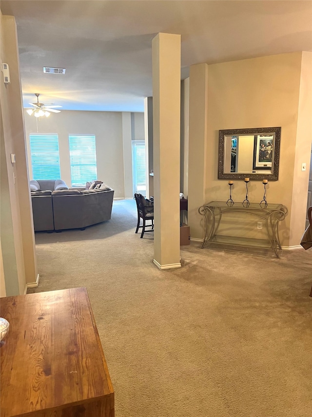 carpeted living room with ceiling fan