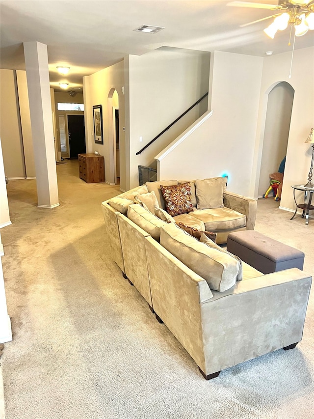 carpeted living room with ceiling fan