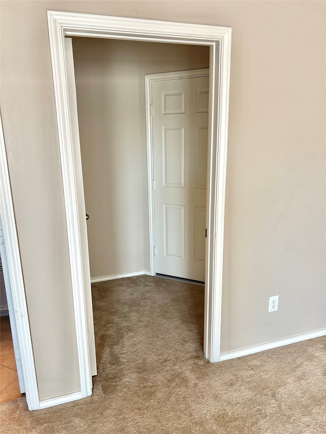 hallway with light colored carpet