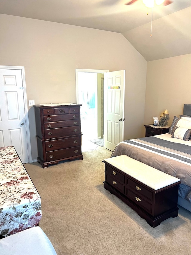 bedroom with ceiling fan, vaulted ceiling, and light colored carpet