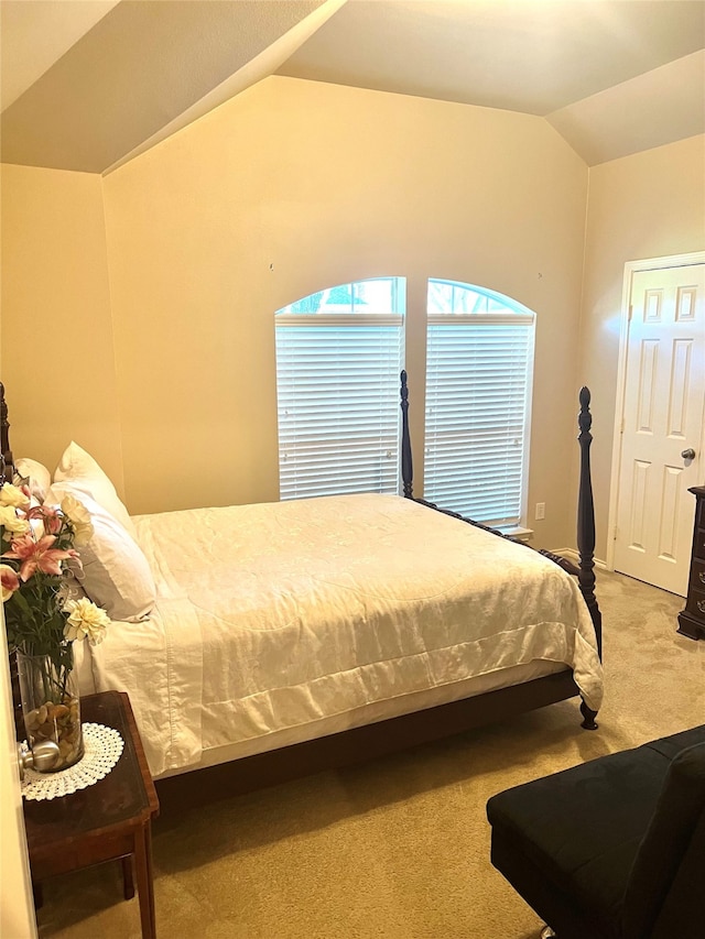 carpeted bedroom featuring vaulted ceiling