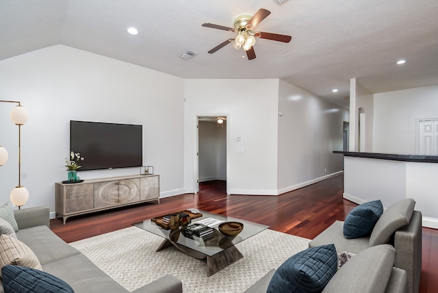 living room with a textured ceiling, ceiling fan, dark hardwood / wood-style flooring, and lofted ceiling