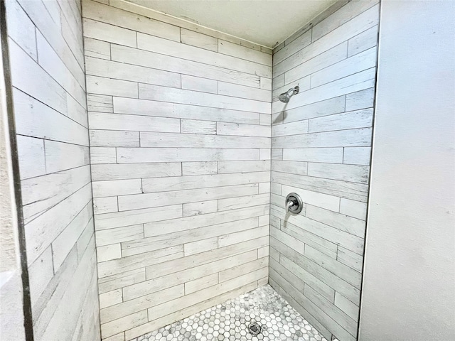 bathroom with tiled shower