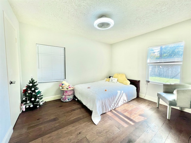 bedroom featuring a textured ceiling and hardwood / wood-style flooring