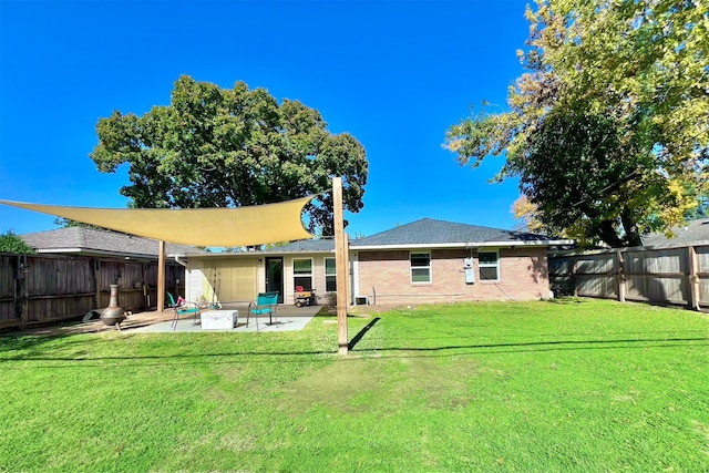 rear view of house with a patio and a lawn