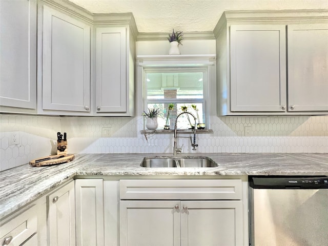 kitchen featuring sink, backsplash, light stone countertops, and dishwasher