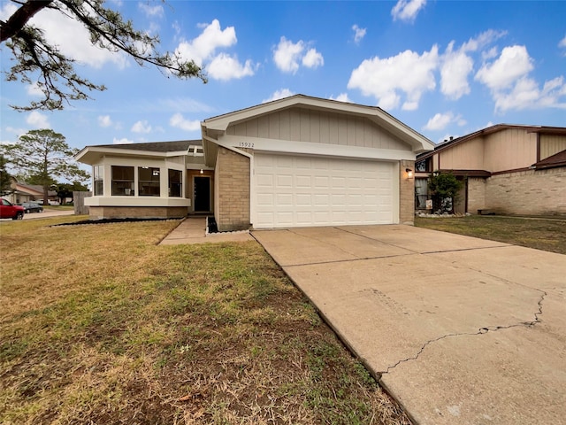 ranch-style home featuring a front lawn and a garage