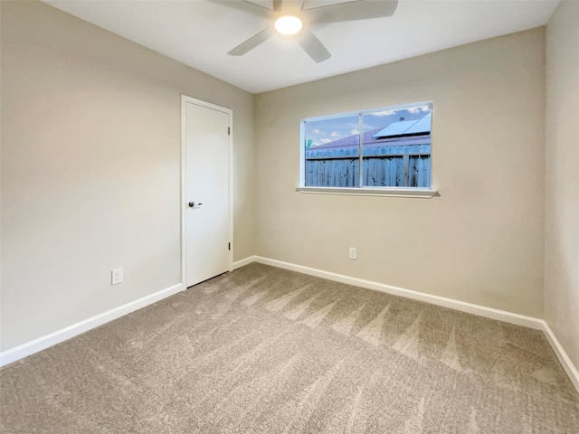 unfurnished room featuring carpet and ceiling fan