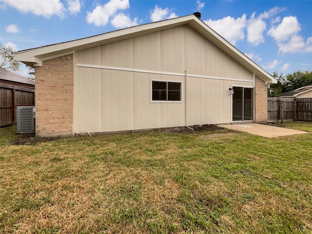 back of property featuring central AC, a yard, and a patio area