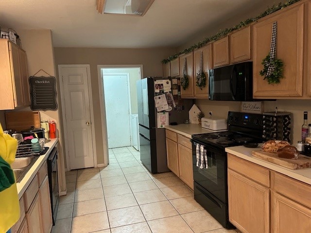 kitchen with light tile patterned flooring and black appliances