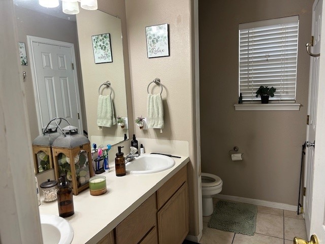 bathroom with vanity, toilet, and tile patterned floors