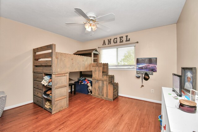 bedroom with ceiling fan and light hardwood / wood-style flooring