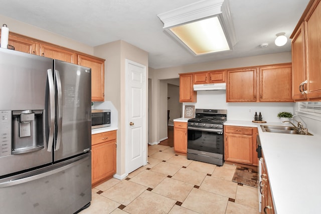 kitchen featuring appliances with stainless steel finishes, light tile patterned floors, and sink