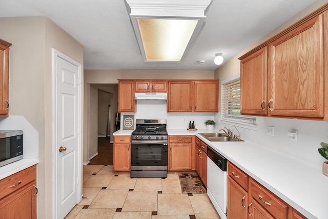 kitchen with sink, light tile patterned floors, and stainless steel appliances